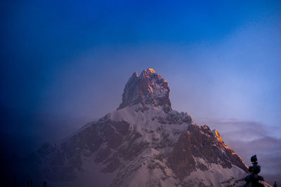 Scenic view of snowcapped mountain against blue sky