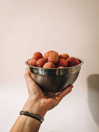 Cropped hand of person holding strawberry