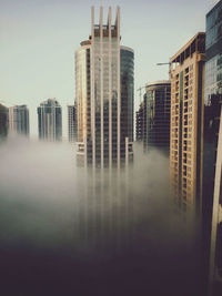 Modern buildings in city against sky