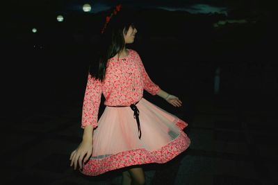 Woman wearing dress standing on floor