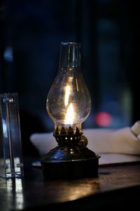 Close-up of illuminated lamp on table