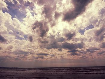 Scenic view of sea against cloudy sky