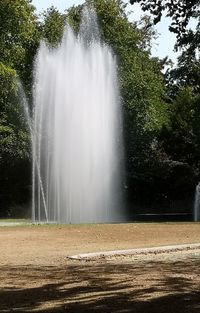 Scenic view of waterfall against trees