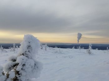 Snow covered field against sky