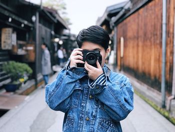 Portrait of young man photographing