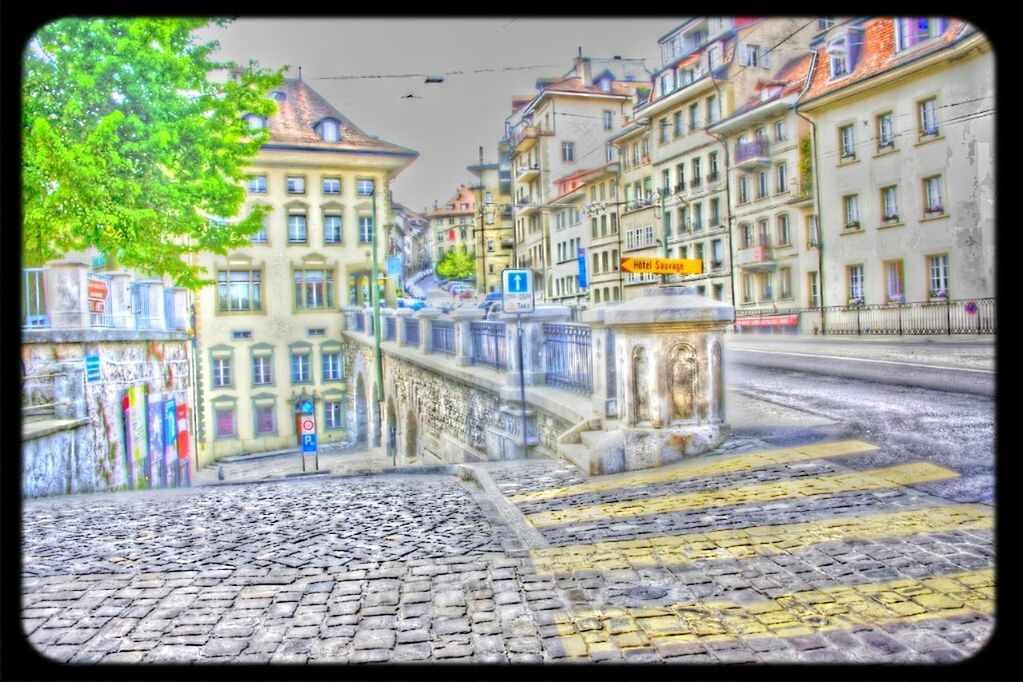 building exterior, architecture, built structure, transfer print, city, street, auto post production filter, cobblestone, residential building, building, residential structure, incidental people, sidewalk, house, city life, day, paving stone, outdoors, road, footpath