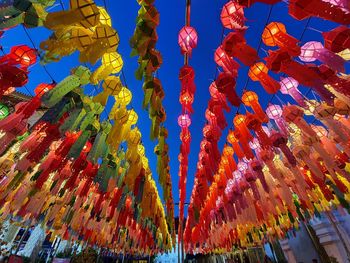 Low angle view of lanterns hanging against sky