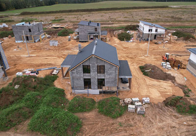 High angle view of houses on field by buildings