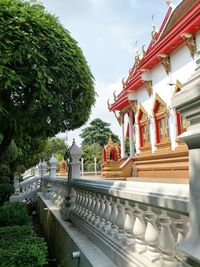 View of temple by building against sky