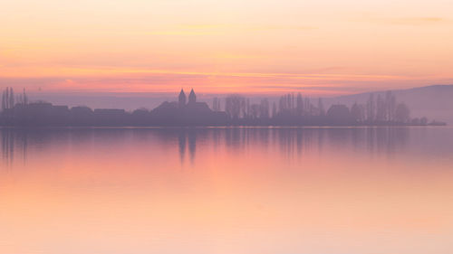 Scenic view of lake against sky during sunset