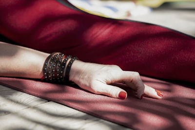 Midsection of woman sitting on couch