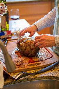 Midsection of woman preparing food in kitchen