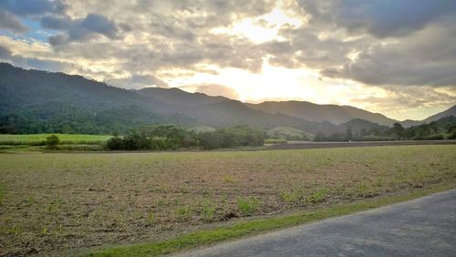 Scenic view of landscape against cloudy sky