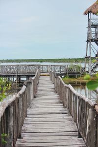 Pier over lake against sky