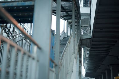 Low angle view of railroad station by building