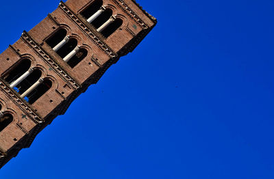 Low angle view of building against clear blue sky