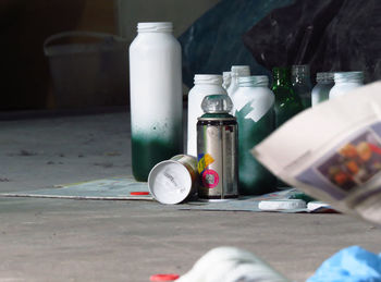 Close-up of spray bottles on floor