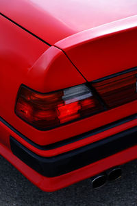 Close-up of red car on road