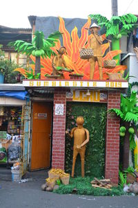 Statue of buddha against built structure