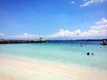 Scenic view of beach against blue sky