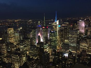 Aerial view of city lit up at night