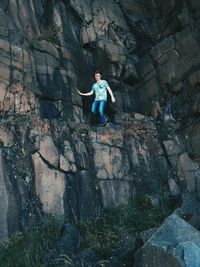 Full length of woman standing on rock formation