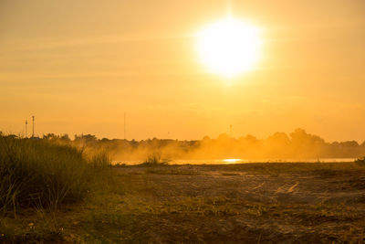 Scenic view of field against sky during sunset