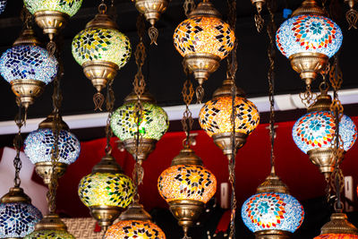 Illuminated lanterns hanging at market stall