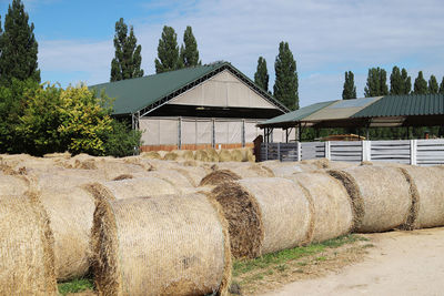 Hay bales on field against sky