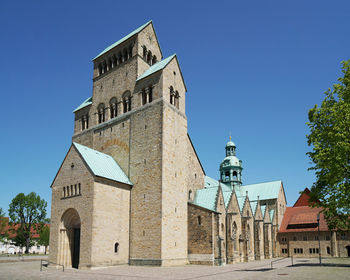 Low angle view of historic building against clear blue sky