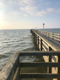 Pier over sea against sky