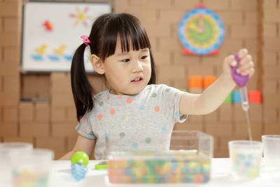 Portrait of cute girl with hands on table