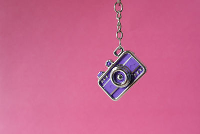 Close-up of electric lamp against pink background