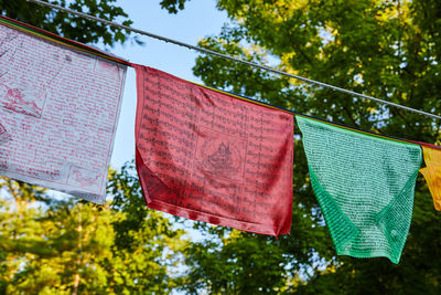 Low angle view of flags hanging against sky