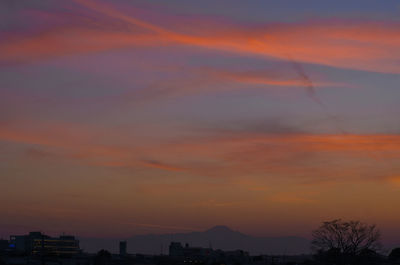 Silhouette buildings against sky during sunset