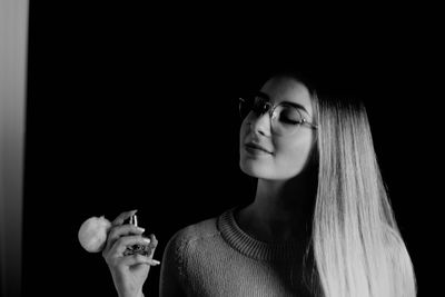 Portrait of smiling woman holding cigarette