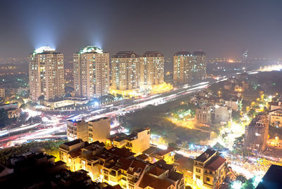 High angle view of illuminated buildings in city at night