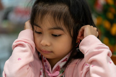 Close-up girl listening music