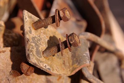 Close-up of rusty nut and bolt on metal