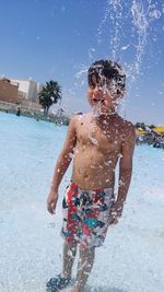 Full length of shirtless boy in swimming pool