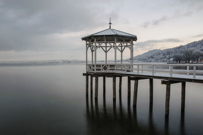 Lifeguard hut in sea against sky