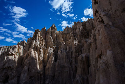 Low angle view of rock formations against sky