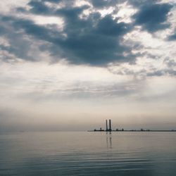 Scenic view of sea against cloudy sky