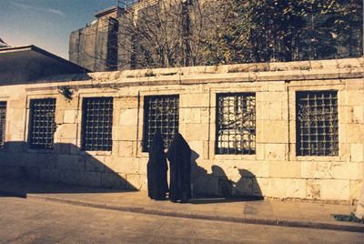Shadow of people on old building