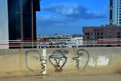 Graffiti on wall with city in background