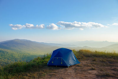 Scenic view of tent on field against sky