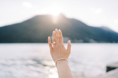 Cropped image of woman against lake