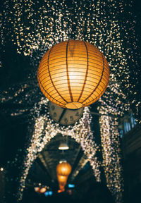 Low angle view of illuminated lanterns hanging on ceiling