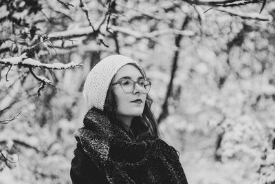 Portrait of woman against trees during winter