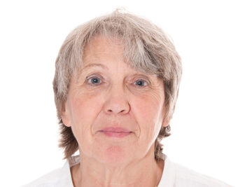 Portrait of mid adult woman against white background